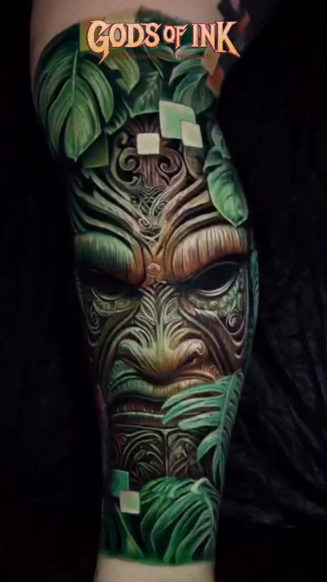 Tiki mask portrait with lush green tropical foliage