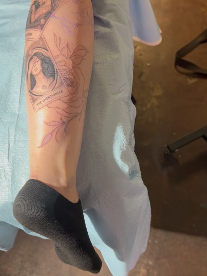 Fine-line tarot card portrait with delicate floral accents