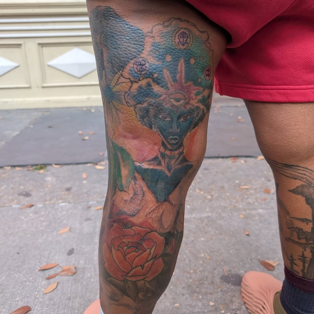 Vibrant watercolor portrait of a blue-robed figure with a rose