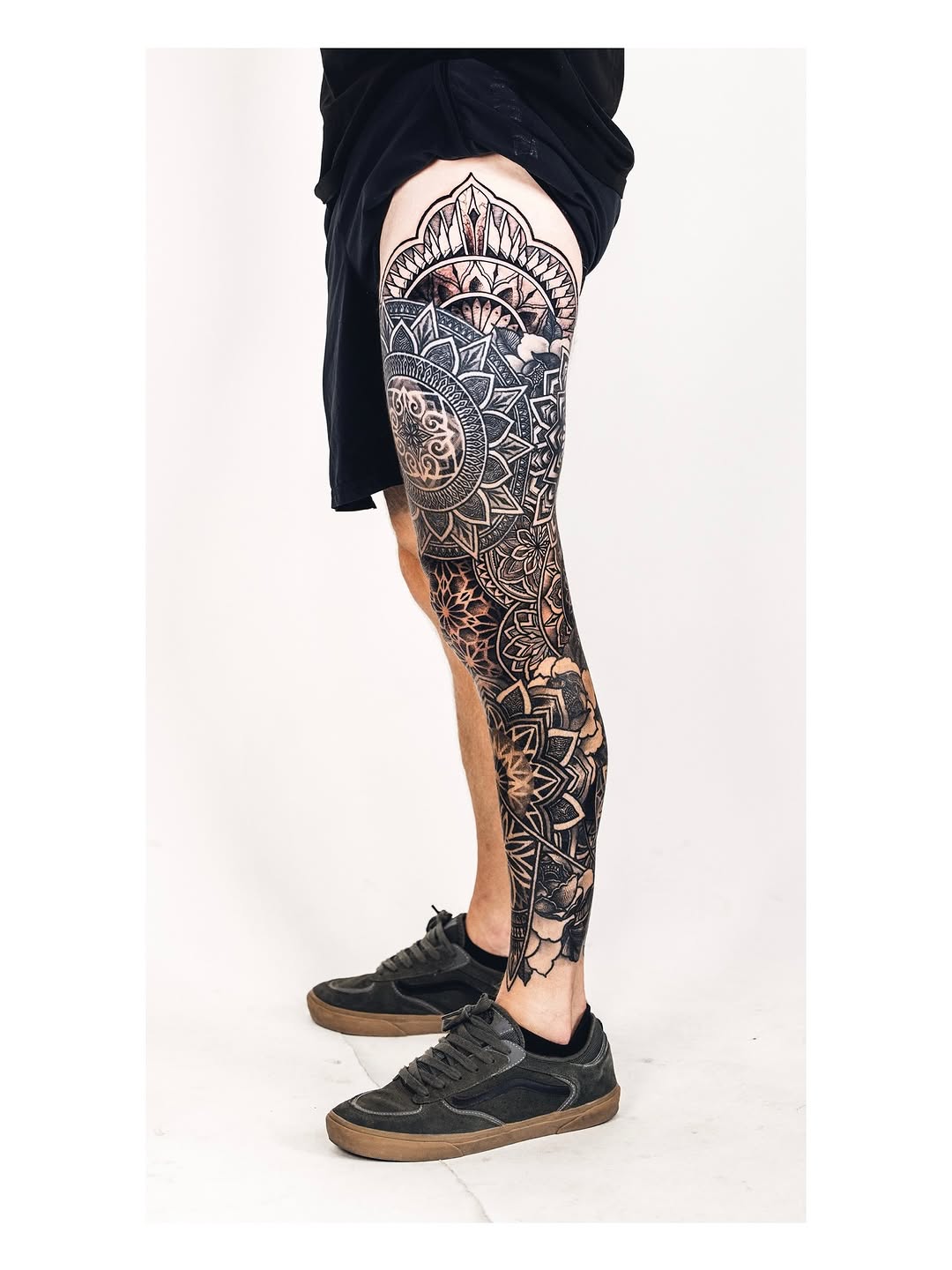 Intricate blackwork mandala leg-sleeve with bold geometric patterns.