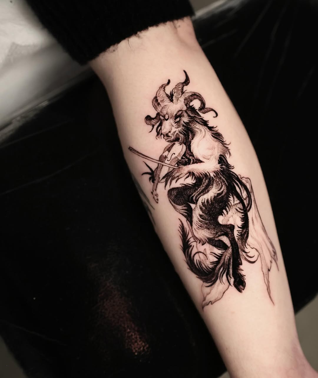 Intricate blackwork demon-goat with curling horns and fur