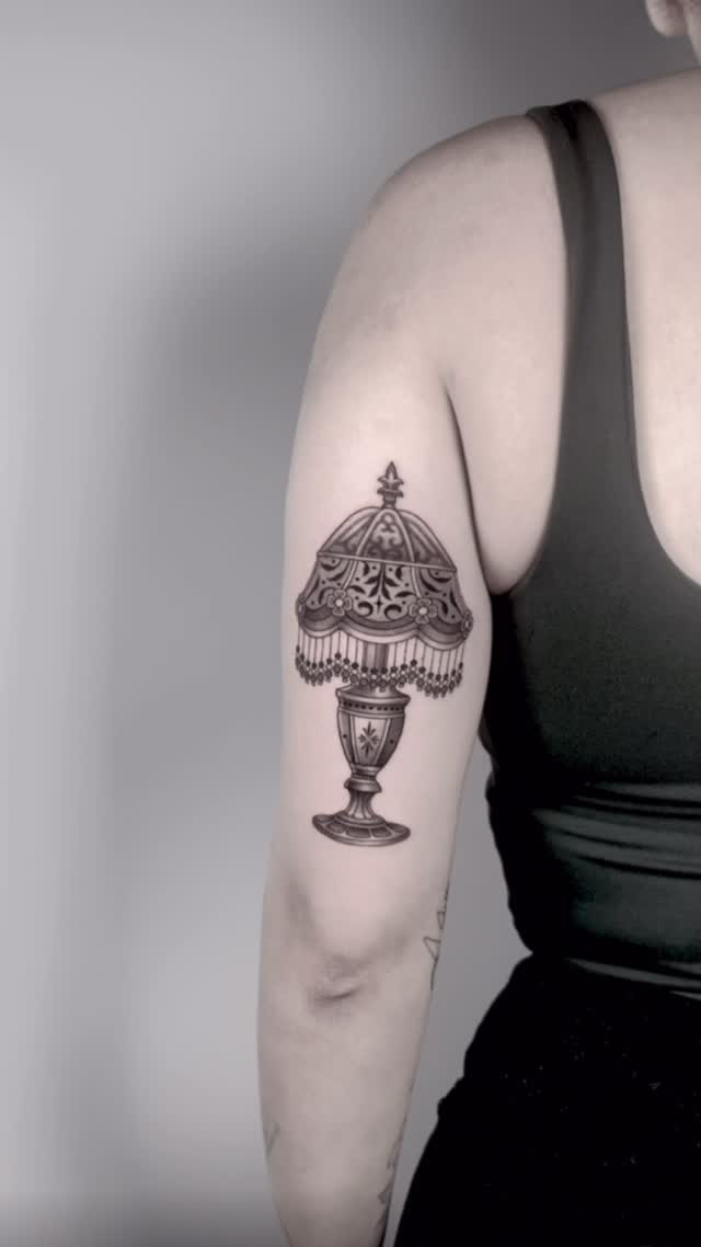 Ornate chandelier-lamp tattoo with beaded fringe