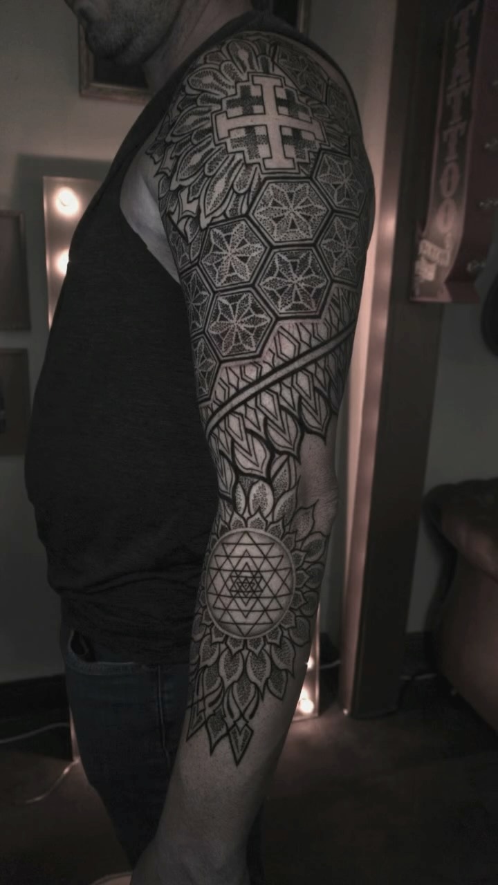 Intricate blackwork full-sleeve with geometric mandalas.