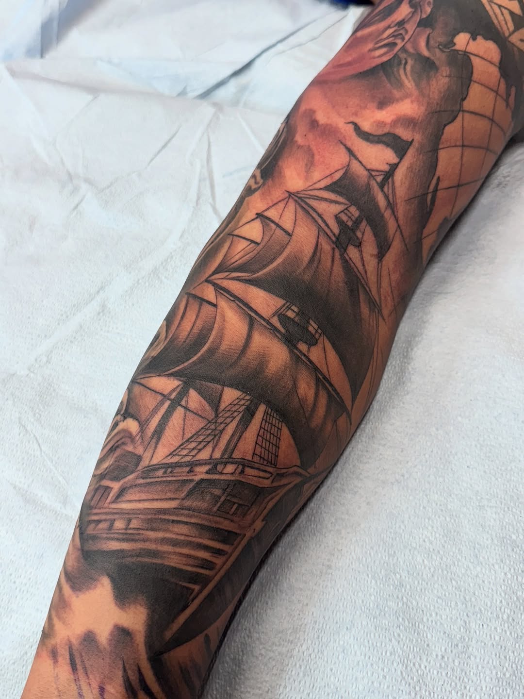 Bold black-and-gray sailing ship with dramatic sails