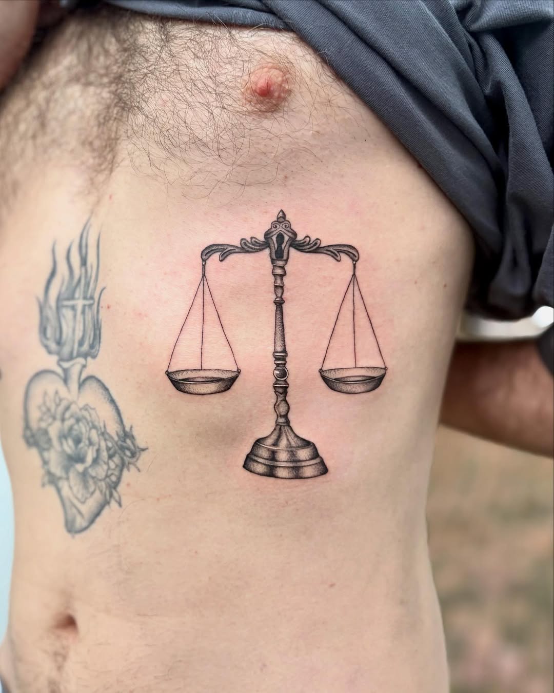 Elegant scales of justice in bold linework with grayscale shading