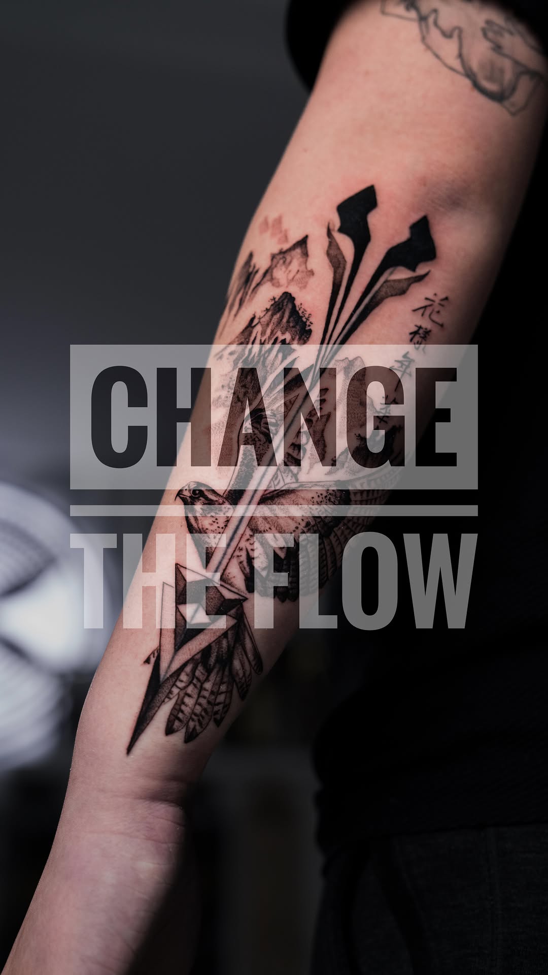 Bold blackwork forearm piece with geometric feathers