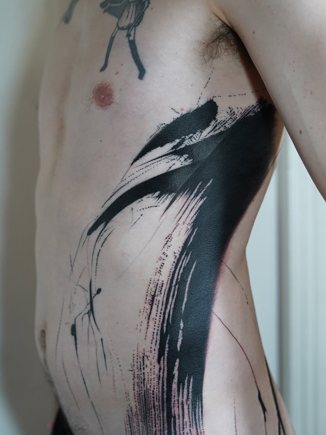 Bold abstract brushstroke arc with ink-splatter texture