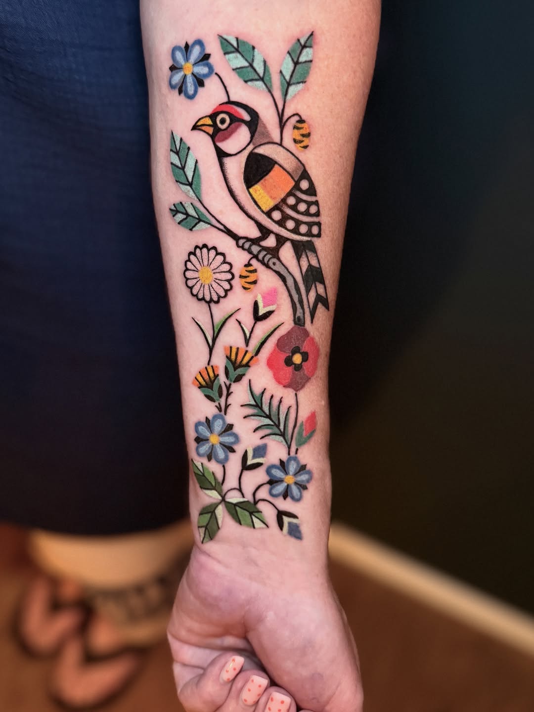 Bold traditional bird on a floral vine with bright colors.