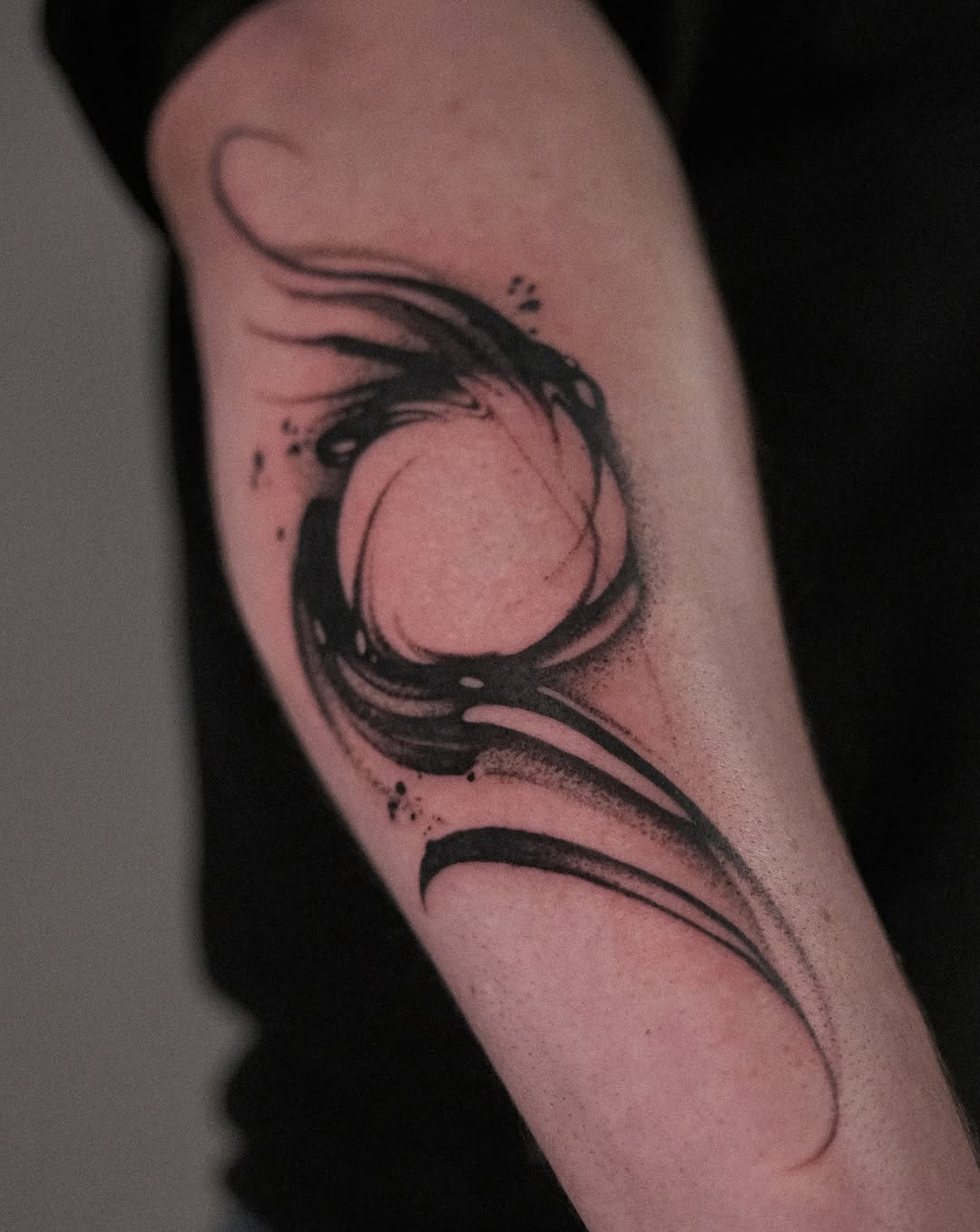 Bold black brushstroke moon encircled by sweeping rings