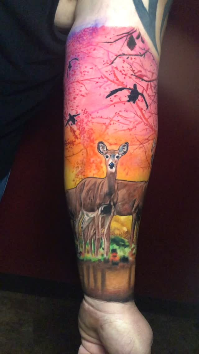 Vibrant watercolor deer at sunset with flying birds