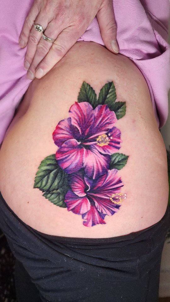 Vibrant hibiscus cover-up on the side torso, bold colors