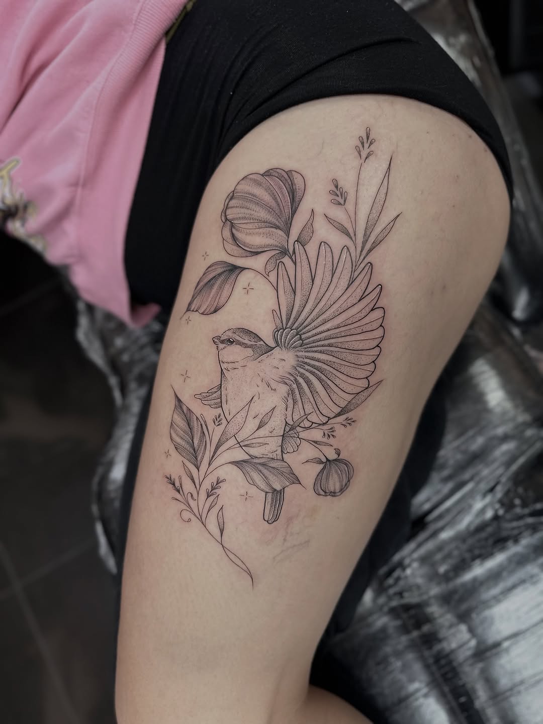 Delicate linework bird among leaves with botanical flair.