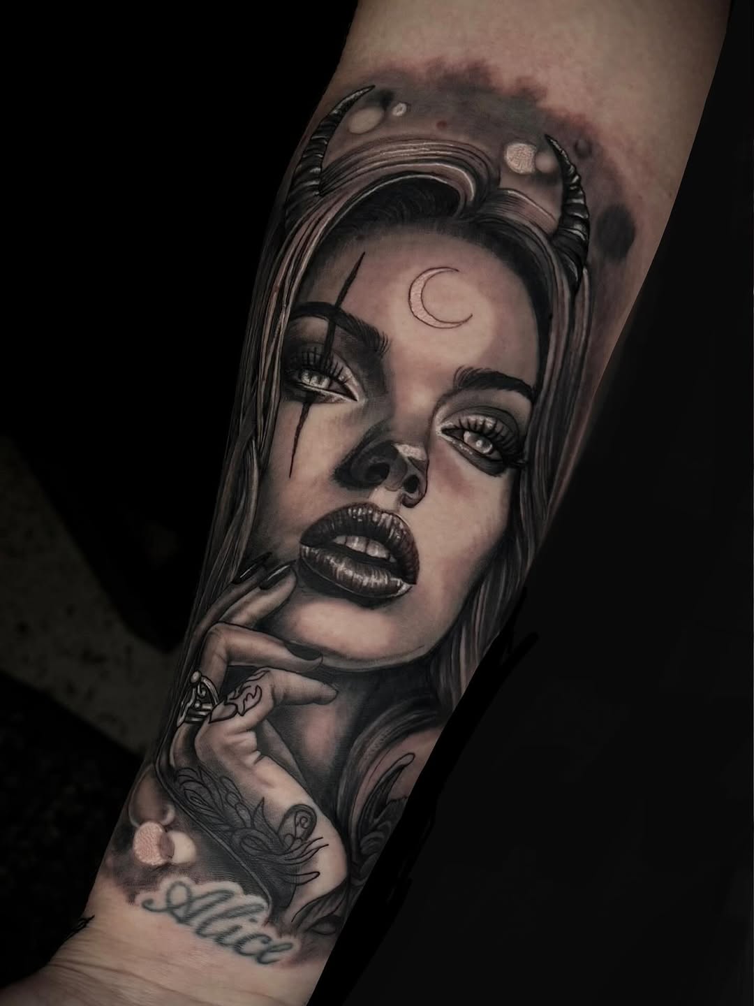 Haunting black-and-gray portrait with crescent moon forehead