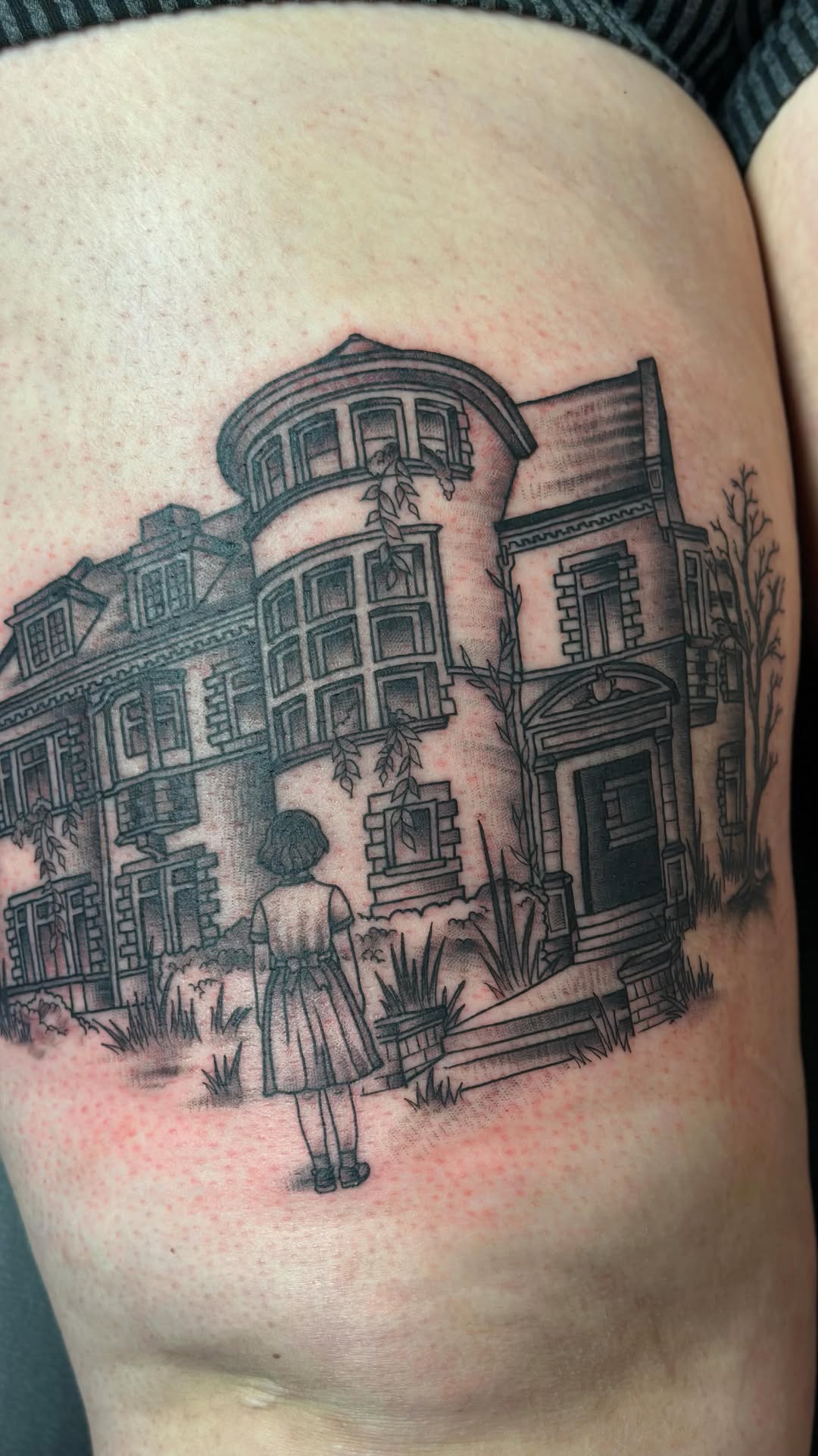 Haunting black-and-gray mansion scene with a lone girl