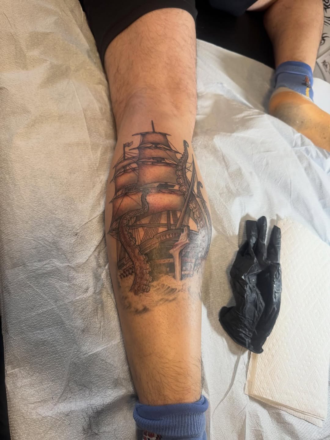 Intricate black-and-gray sailing ship with tentacles