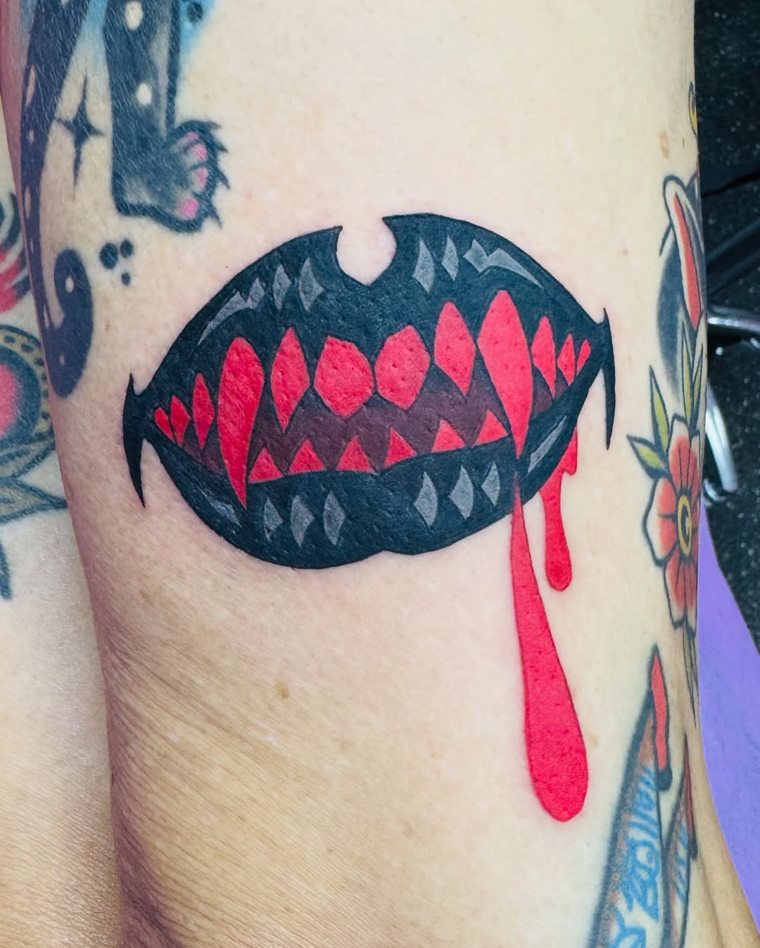 Bold vampire bite tattoo with dripping crimson blood