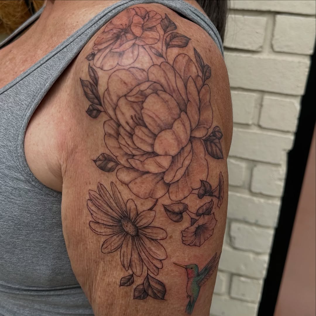 Delicate botanical bouquet with peonies, leaves, and hummingbird