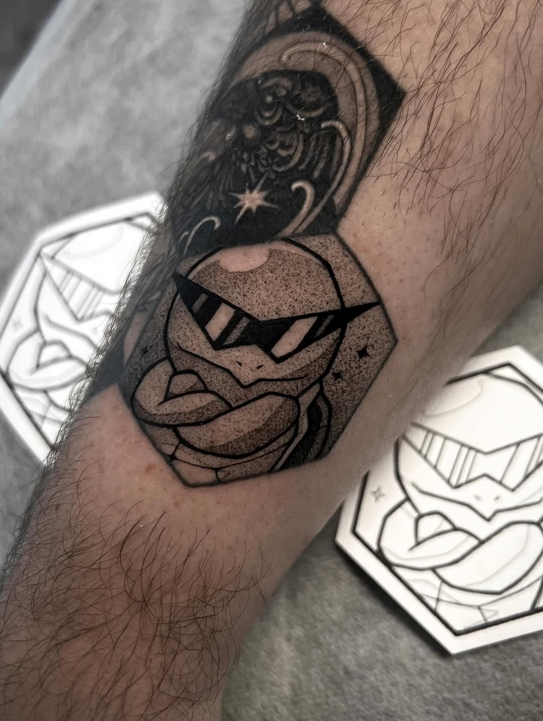Bold blackwork turtle head with sunglasses and dot shading.