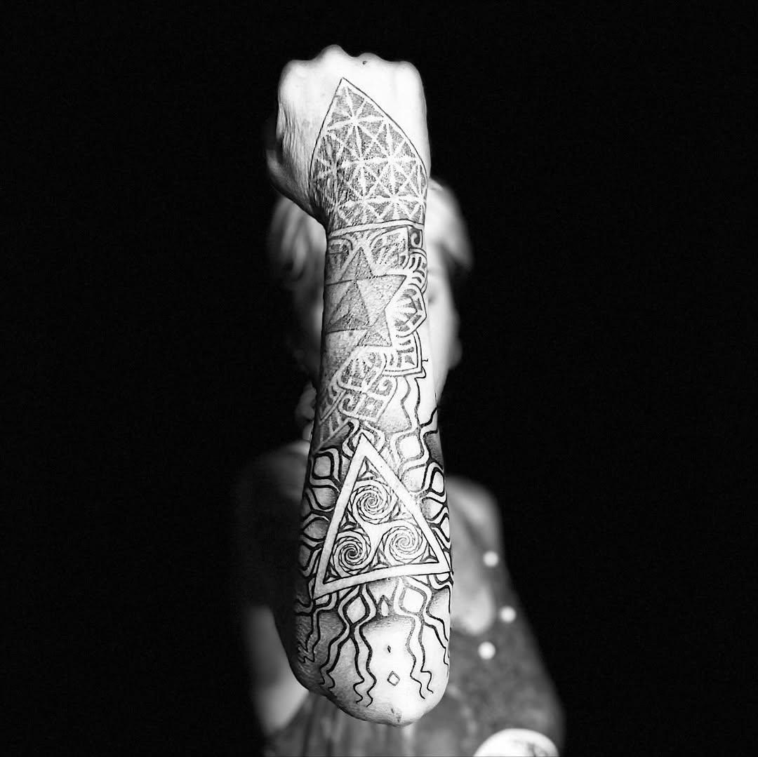 Bold geometric forearm sleeve with triangles and swirling linework