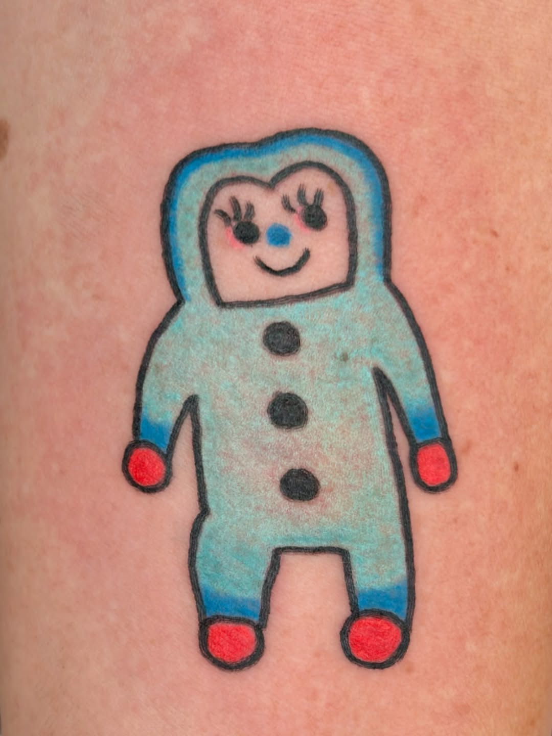Whimsical cartoon figure with blue shading and buttons