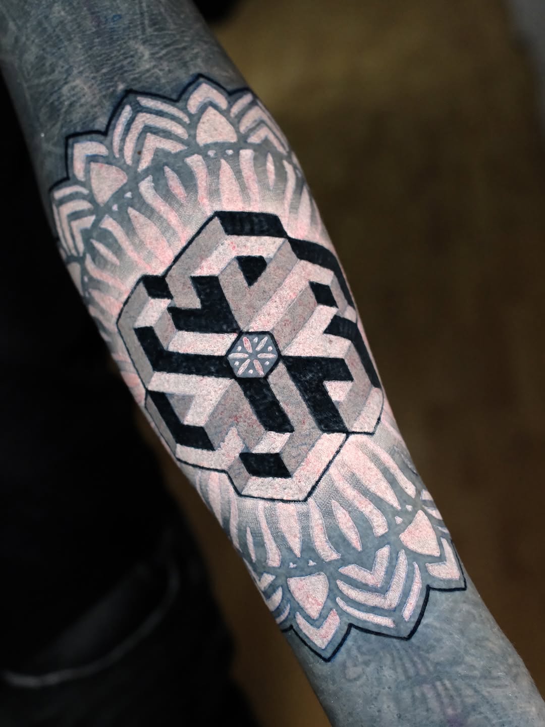 Bold black-and-grey geometric hex motif with mandala accents