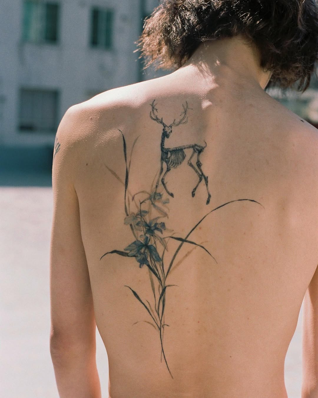 Delicate blackwork deer skeleton entwined with tall florals