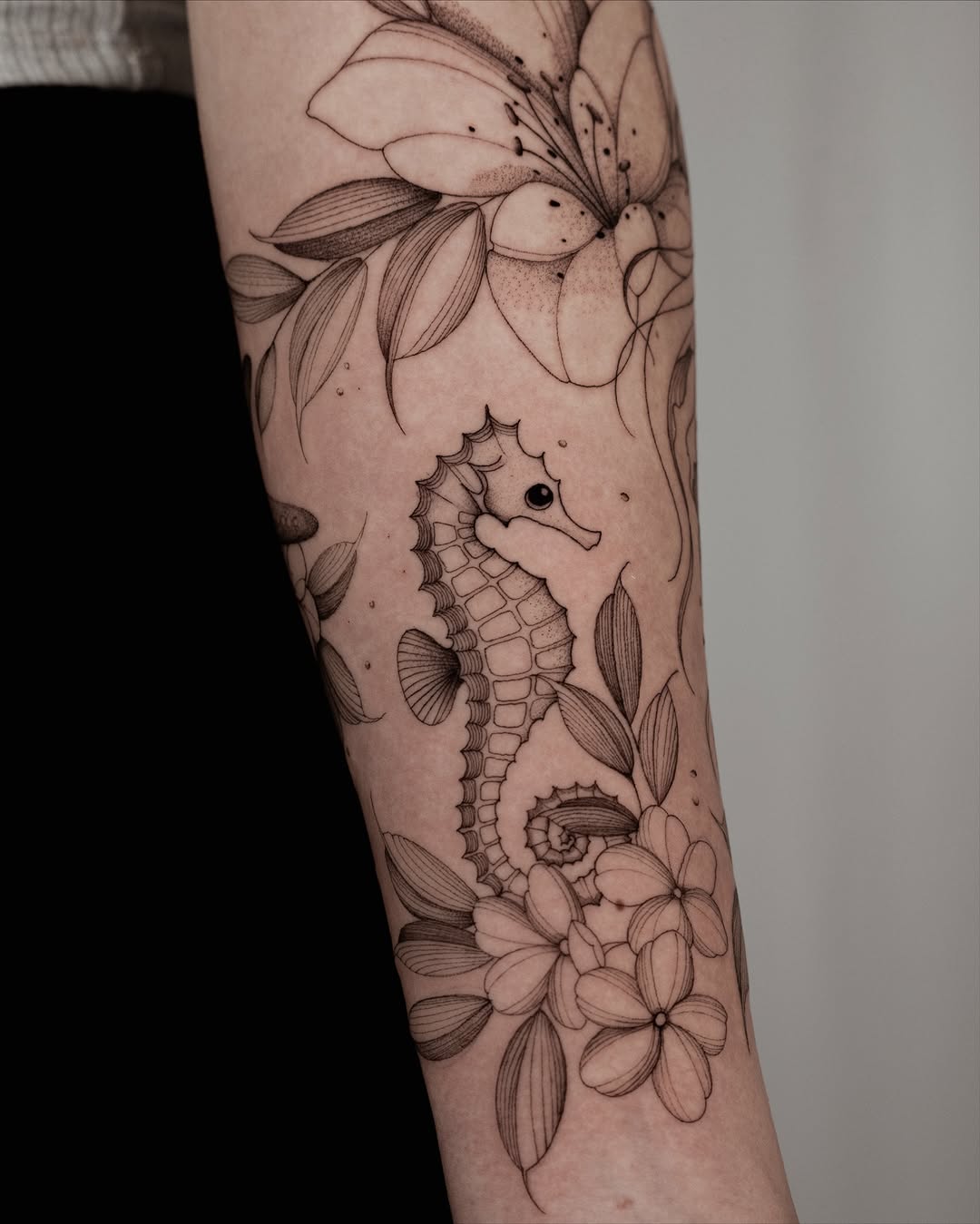 Delicate fine-line seahorse with blooming florals