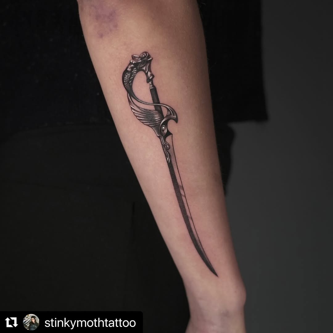 Intricately detailed fantasy dagger with winged guard.