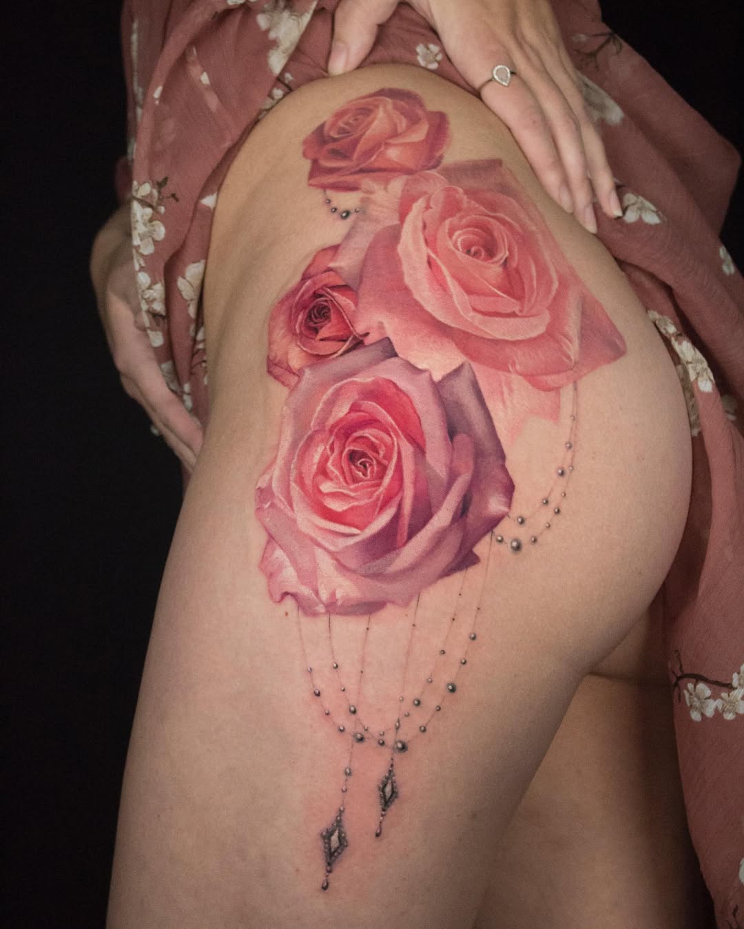 Vibrant pink roses with delicate beadwork cascading.