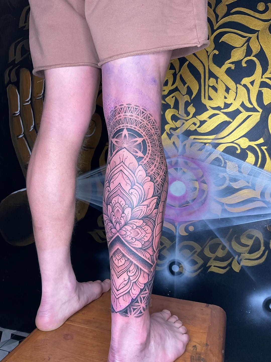 Ornate blackwork mandala with lotus petals on shin