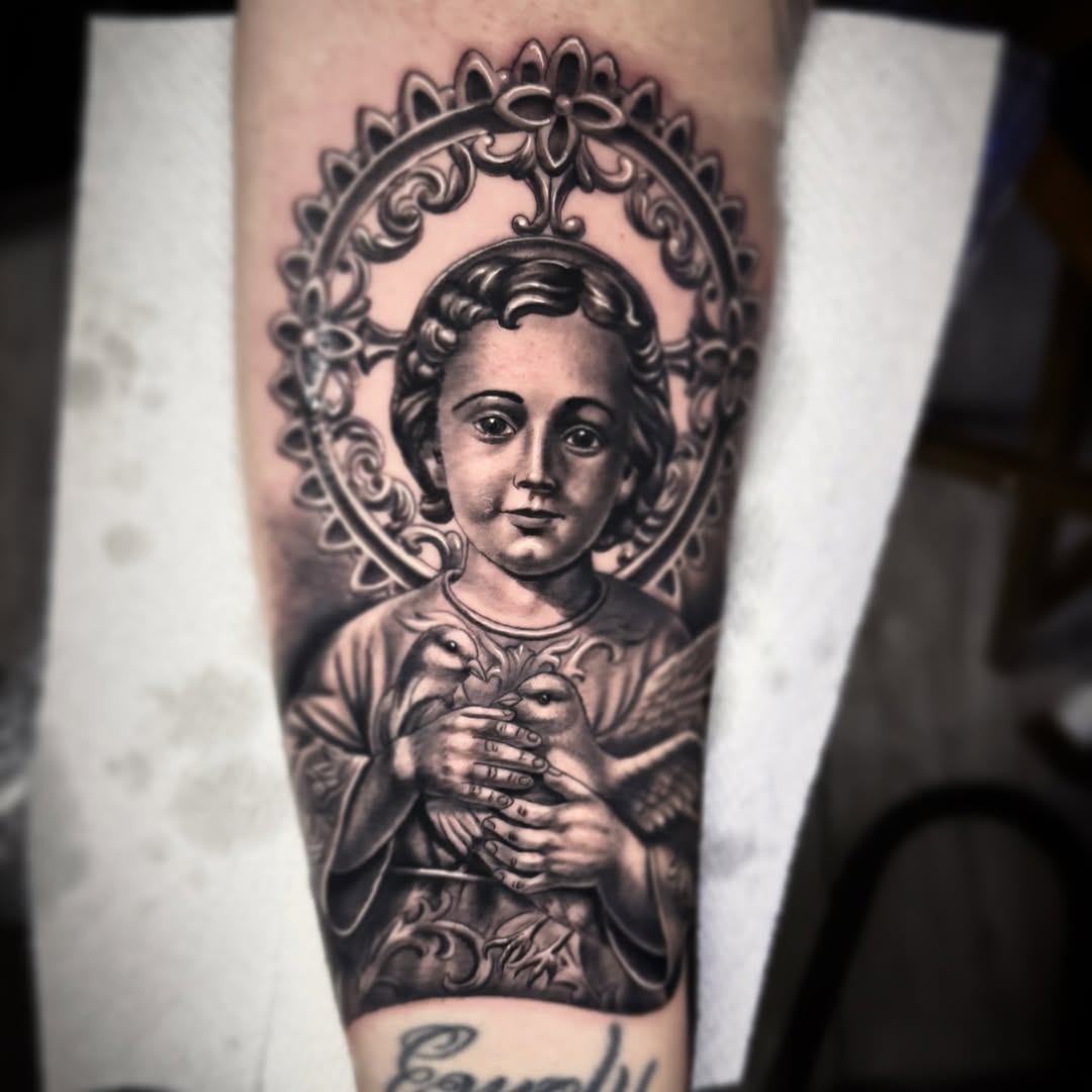 Religious infant portrait with ornate halo in grayscale.