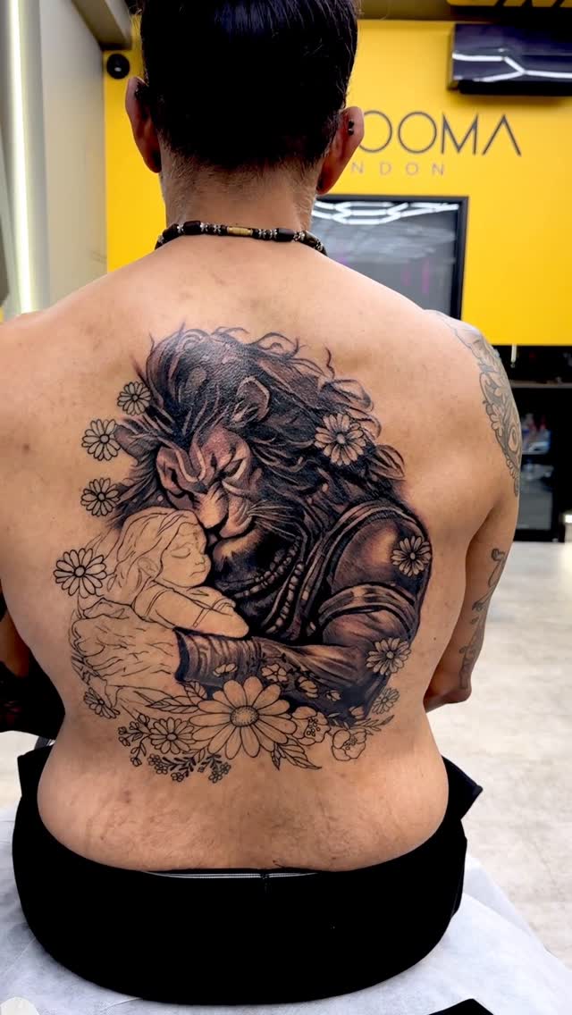 Bold black-and-gray Narasimha back piece with daisies