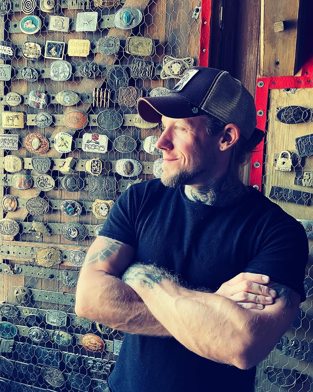 Stoic man sporting bold blackwork neck and arm tattoos