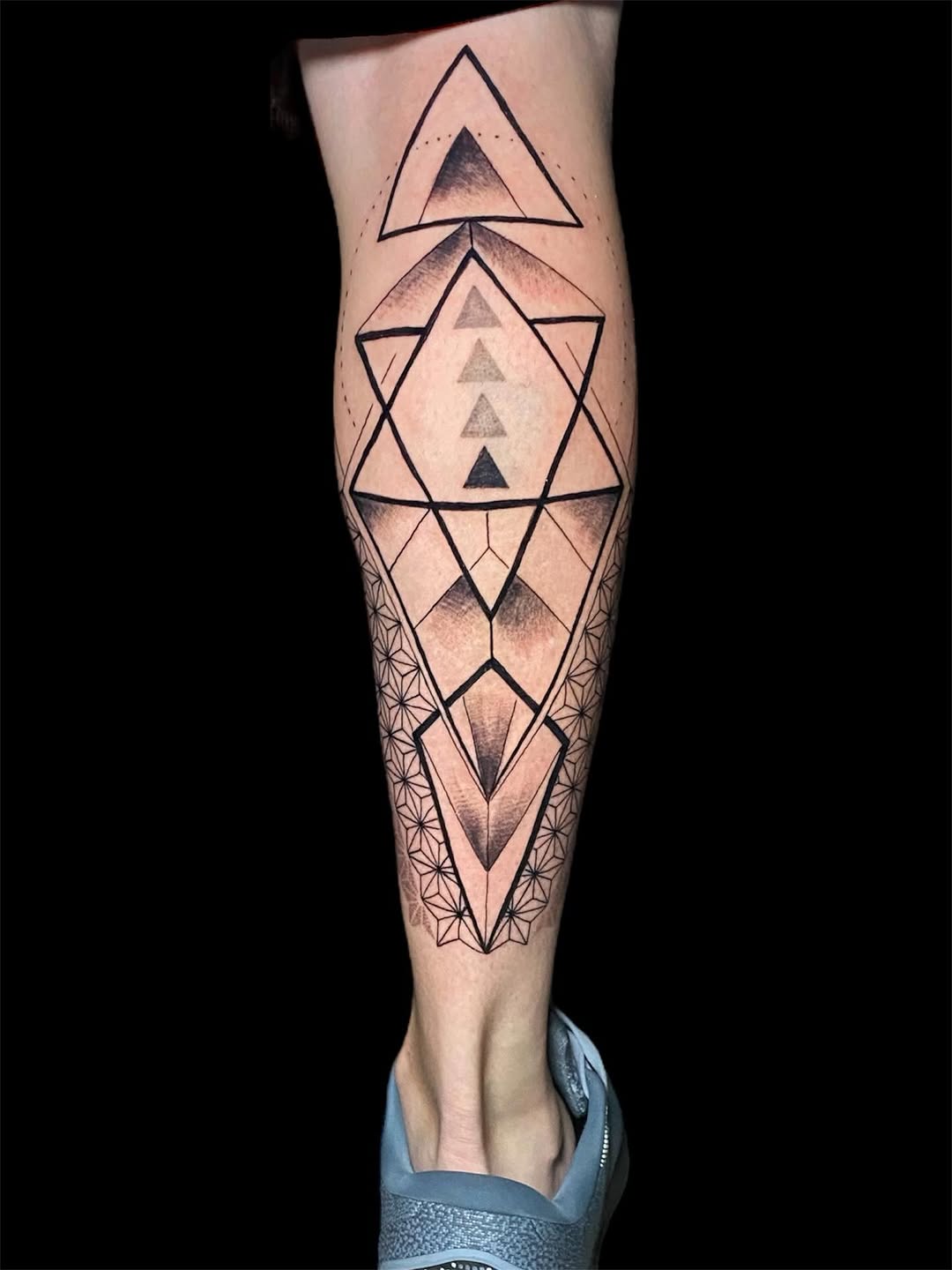Intricate geometric leg sleeve with interlocking triangles and shading