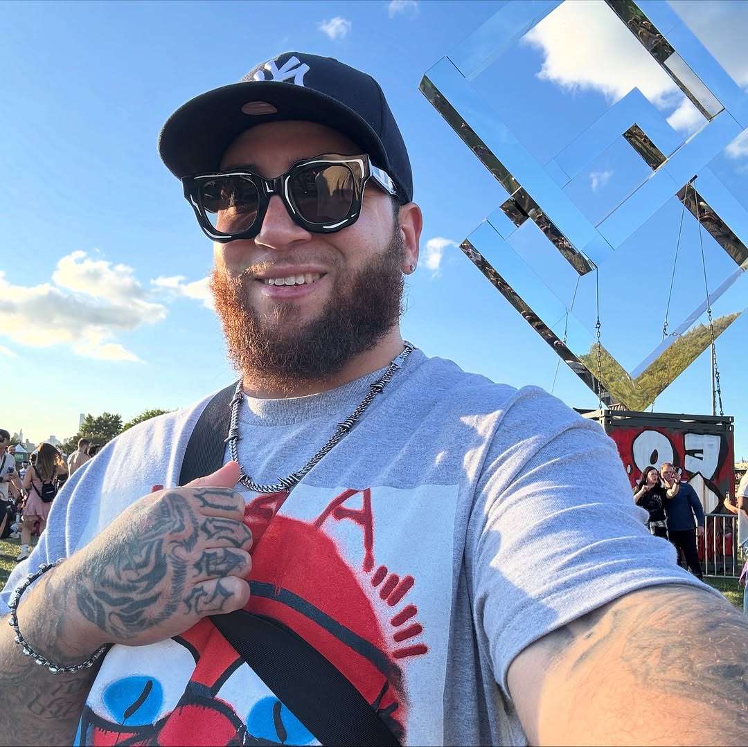 Selfie of bearded man showing bold blackwork forearm tattoos