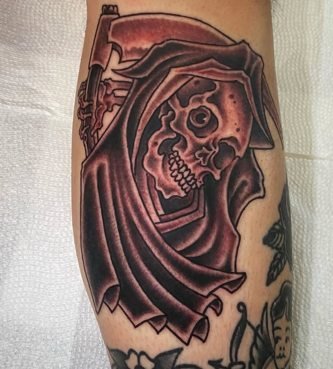 Hooded Grim Reaper skull in bold, shaded blackwork.
