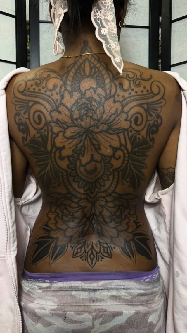 Ornamental blackwork back piece with mandala-inspired florals