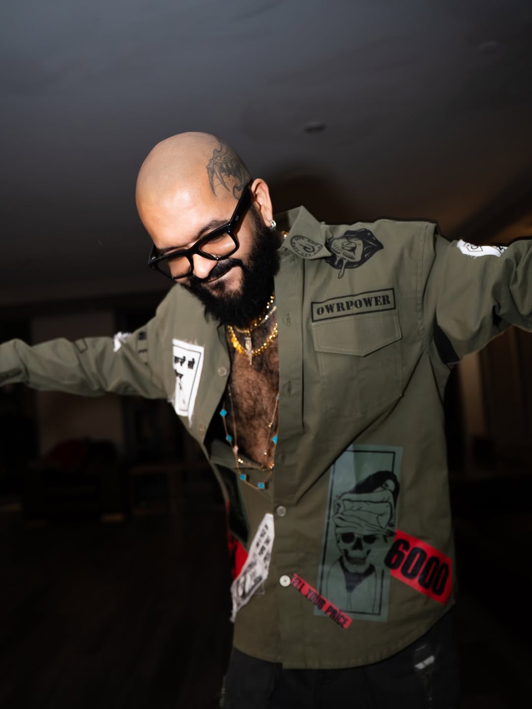 Bold head tattoo near temple, dark winged design