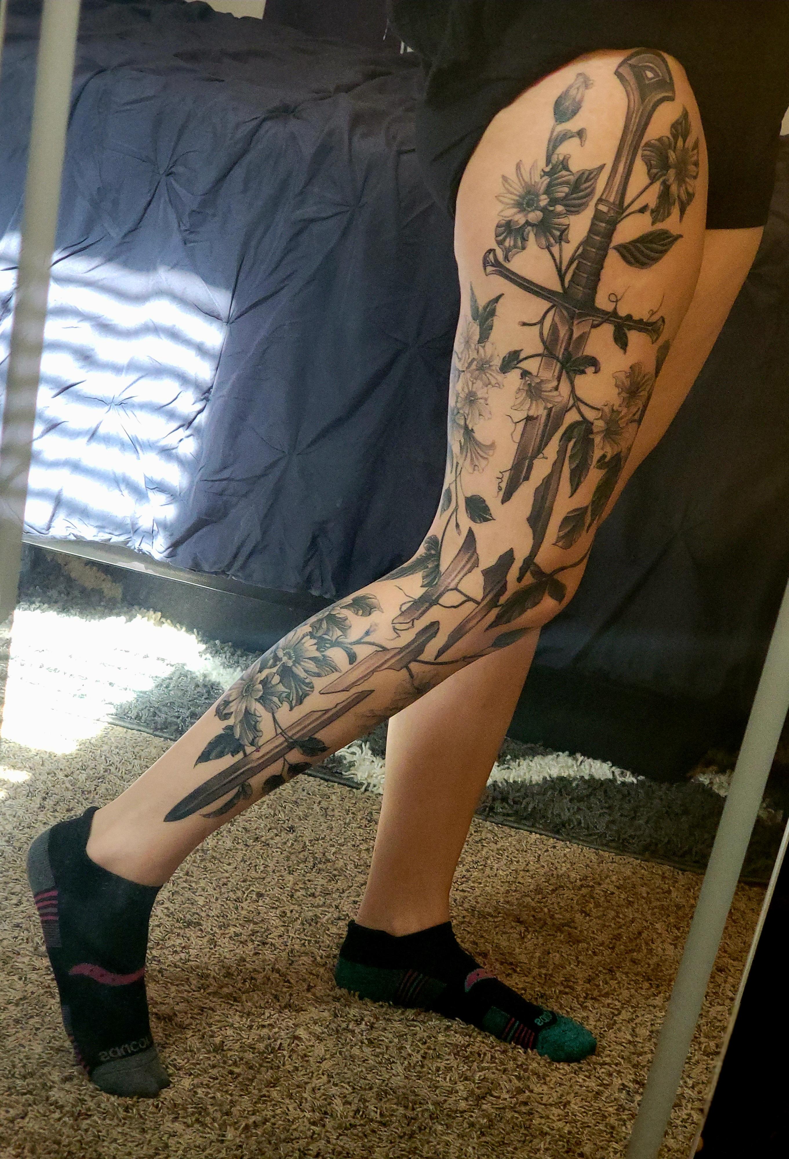 Intricate blackwork sword sleeve entwined with florals