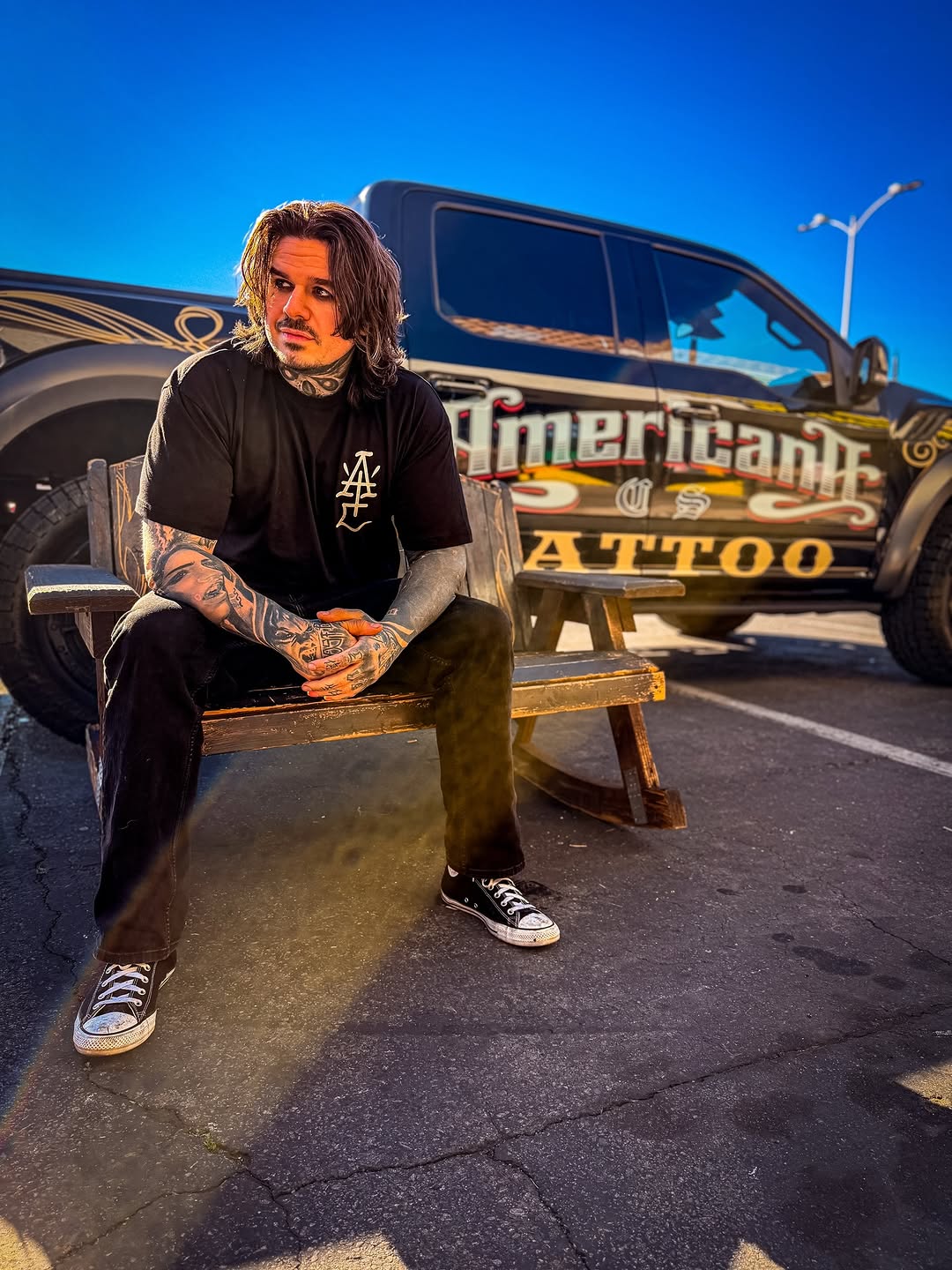 Bold blackwork sleeves adorn tattooed arms, urban vibe