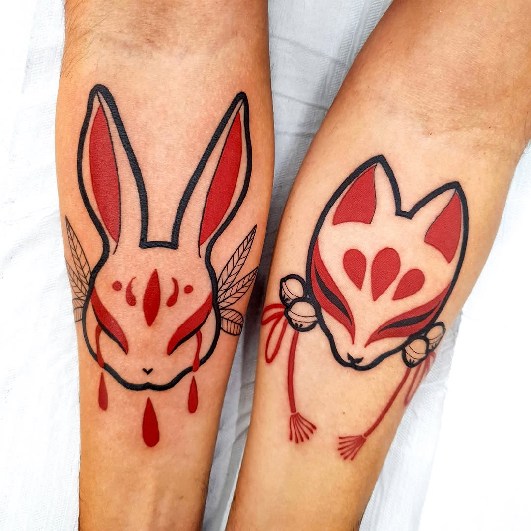 Bold red-and-black rabbit and fox face tattoos