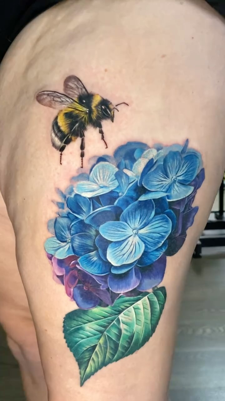 Vivid blue hydrangea bouquet with a lifelike bee