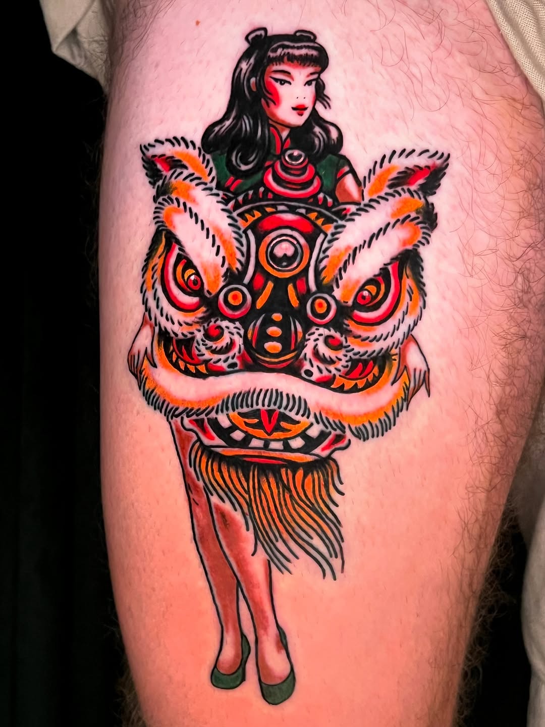 Vibrant lion-dance pin-up atop stylized guardian lion.