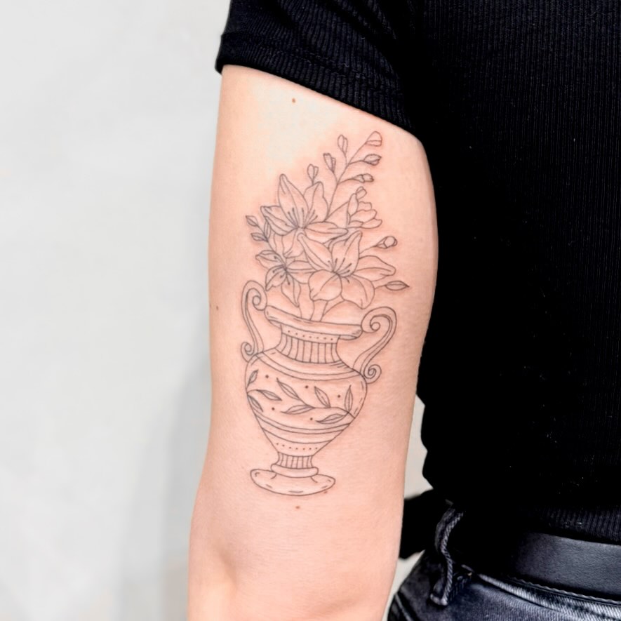 Delicate linework floral vase with blooming bouquet