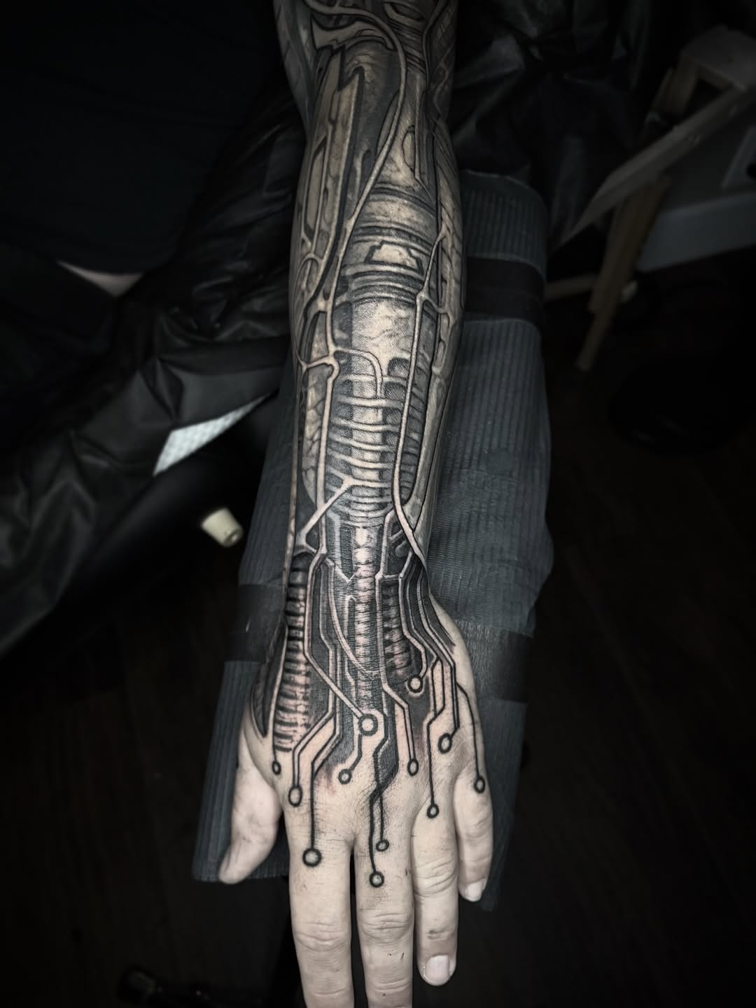 Intricate black-gray biomechanical sleeve with circuit wiring