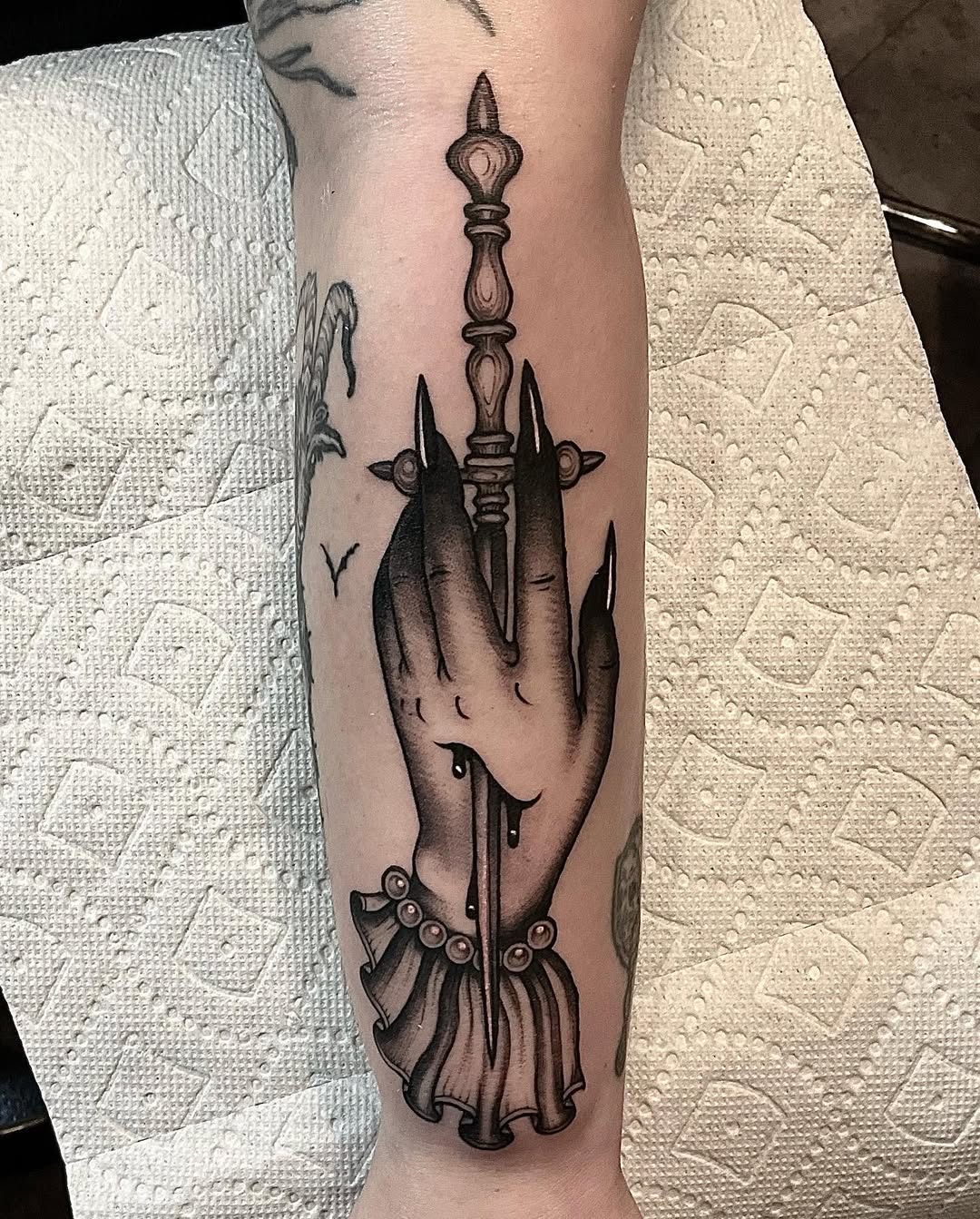 Gothic hand clutching ornate dagger, bold blackwork