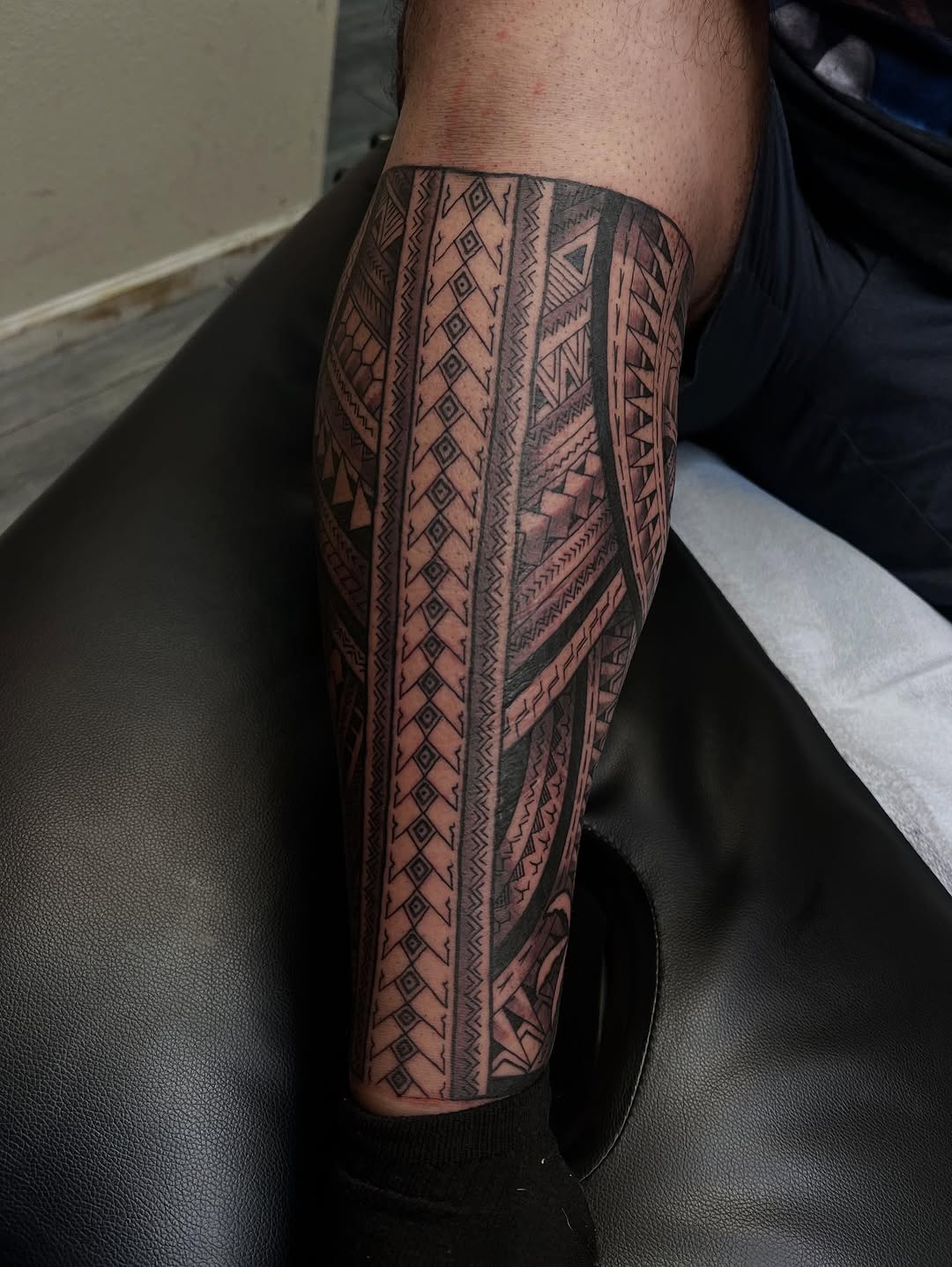 Intricate Polynesian geometric leg sleeve in blackwork