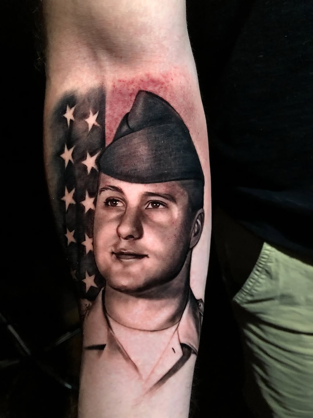 Grayscale veteran soldier portrait with flag backdrop, bold realism