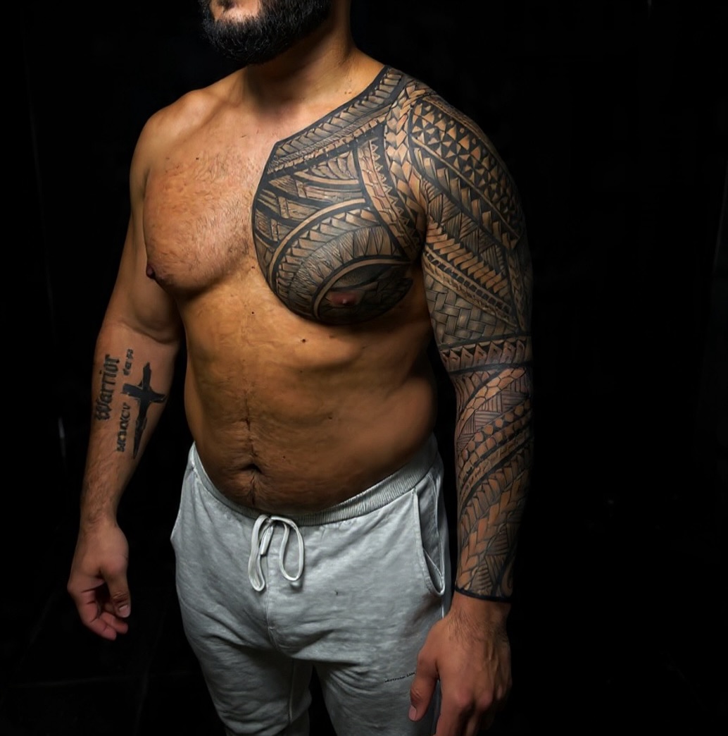 Polynesian-inspired blackwork tribal sleeve with bold geometric patterns