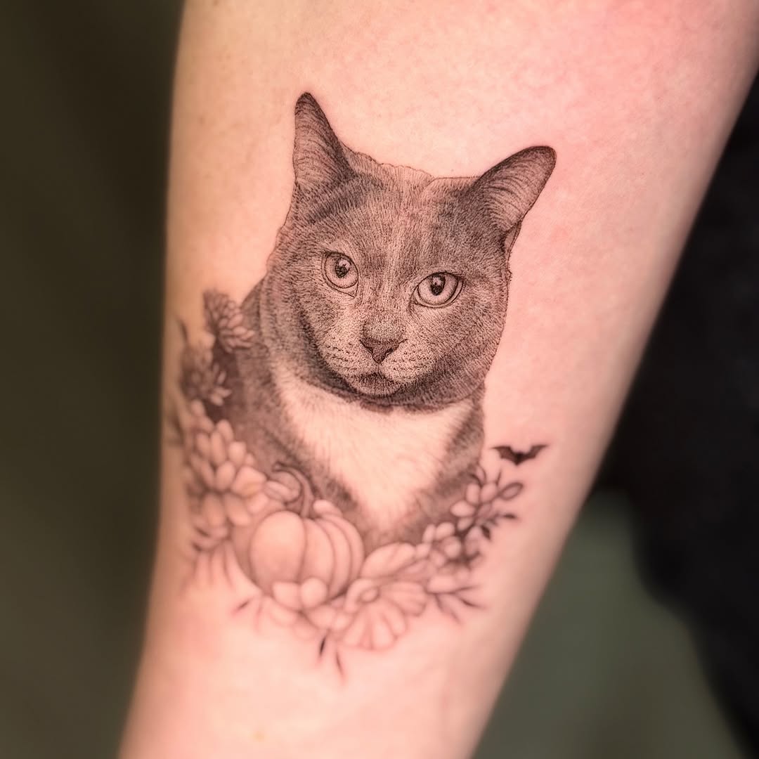 Whimsical black-and-gray cat portrait framed by delicate florals